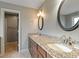 Double vanity bathroom with granite countertops and tiled floor at 7042 Confederate Ct, Villa Rica, GA 30116