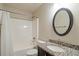 Clean bathroom with shower/tub combo, granite vanity, and oval mirror at 7042 Confederate Ct, Villa Rica, GA 30116