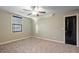 Bright bedroom featuring neutral walls, carpet, and ceiling fan at 7042 Confederate Ct, Villa Rica, GA 30116