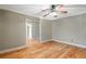 Hardwood floor bedroom with ceiling fan and access to another room at 7042 Confederate Ct, Villa Rica, GA 30116