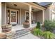 Front porch with two wicker chairs, planters, and a double door entry at 7042 Confederate Ct, Villa Rica, GA 30116