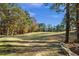 Picturesque golf course view with wooded surroundings at 7042 Confederate Ct, Villa Rica, GA 30116