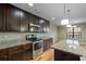 Kitchen with dark cabinets, granite countertops, and stainless steel appliances at 7042 Confederate Ct, Villa Rica, GA 30116