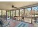 Enjoy this screened porch with wooded views and seating area at 7042 Confederate Ct, Villa Rica, GA 30116