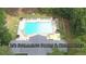 Large community pool with plenty of lounge chairs and umbrellas at 7042 Confederate Ct, Villa Rica, GA 30116