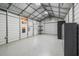 Spacious workshop with roll-up door and epoxy floor at 7042 Confederate Ct, Villa Rica, GA 30116