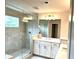 Spacious bathroom featuring a glass enclosed shower, double vanity with white countertops, and modern fixtures at 1059 Crest Mill Dr, Marietta, GA 30008