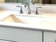 Close up of a modern bathroom vanity with white countertop, chrome fixtures, and ample storage space at 1059 Crest Mill Dr, Marietta, GA 30008
