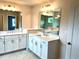 Large bathroom featuring a double vanity, with white counter tops, modern fixtures, and large mirrors at 1059 Crest Mill Dr, Marietta, GA 30008