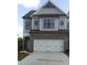 Beautiful home with a brick and siding facade, a three-car garage, and modern black trimmed windows at 1059 Crest Mill Dr, Marietta, GA 30008