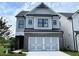 Charming two-story home featuring a brick front, two-car garage, and classic architectural details at 1059 Crest Mill Dr, Marietta, GA 30008