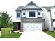 Charming two-story home showcasing a brick and siding exterior, attached two car garage, and well manicured lawn at 1059 Crest Mill Dr, Marietta, GA 30008