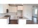Bright kitchen featuring white cabinets, granite countertops, stainless steel appliances, and an island with a sink at 1059 Crest Mill Dr, Marietta, GA 30008
