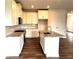 Bright kitchen with white cabinets, granite countertops, stainless steel appliances, and a center island with sink at 1059 Crest Mill Dr, Marietta, GA 30008