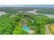 Birds-eye view of community amenities including clubhouse, tennis courts, and pools amid lush greenery at 413 Solace Pl, Canton, GA 30114