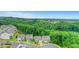 Aerial view of a home in a community surrounded by mature trees with a glimpse of a lake at 413 Solace Pl, Canton, GA 30114