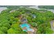 Aerial view featuring community clubhouse, pool, tennis courts, and scenic lake backdrop at 413 Solace Pl, Canton, GA 30114