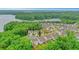 Aerial view showcases the neighborhood near the water and a home with a deck and fenced yard at 413 Solace Pl, Canton, GA 30114