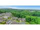 An elevated view of the home and its surrounding suburban neighborhood near a tranquil lake at 413 Solace Pl, Canton, GA 30114