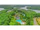 Aerial view of homes near a lake and community amenities including pools and tennis courts at 413 Solace Pl, Canton, GA 30114