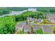 Aerial view of a home in a community by the lake with mature trees and blue skies at 413 Solace Pl, Canton, GA 30114