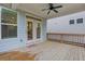 Back porch with ceiling fan, wood floors, and windows overlooks the backyard at 413 Solace Pl, Canton, GA 30114