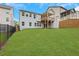 Spacious backyard of a two-story home, featuring a wooden deck and walkout basement at 413 Solace Pl, Canton, GA 30114