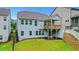Backyard view showing a covered deck with outdoor access, complemented by a retaining wall at 413 Solace Pl, Canton, GA 30114