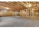 Spacious unfinished basement with exposed ceilings and wooden framing. Customize to your liking at 413 Solace Pl, Canton, GA 30114