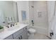 Modern bathroom with gray vanity, white subway tile, and bathtub at 413 Solace Pl, Canton, GA 30114