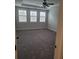 Spacious main bedroom with gray carpet, a ceiling fan, and large windows at 413 Solace Pl, Canton, GA 30114