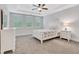 Bright bedroom features a tray ceiling, plush carpet, and double windows letting in natural light at 413 Solace Pl, Canton, GA 30114