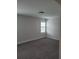 Bright bedroom featuring neutral walls, carpeting, and a window with shutters at 413 Solace Pl, Canton, GA 30114