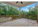 This is a beautiful covered wooden deck with a ceiling fan and views of the trees at 413 Solace Pl, Canton, GA 30114