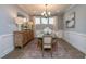 Elegant dining room with chandelier, wainscoting, wood floors, and traditional furniture at 413 Solace Pl, Canton, GA 30114