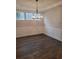 Bright dining room features hardwood floors and elegant chandelier at 413 Solace Pl, Canton, GA 30114
