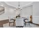 Bright dining area featuring hardwood floors, wainscoting, and modern chandelier at 413 Solace Pl, Canton, GA 30114