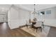 Cozy dining room with hardwood floors, decorative rug, and modern chandelier at 413 Solace Pl, Canton, GA 30114