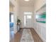 Bright foyer with hardwood floors, wainscoting, and an ocean-themed painting at 413 Solace Pl, Canton, GA 30114