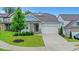 Charming home featuring stone accents, blue siding, well-manicured landscaping, and a two-car garage at 413 Solace Pl, Canton, GA 30114
