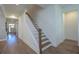 Hallway view with hardwood floors and a staircase with white railings and wooden handrail at 413 Solace Pl, Canton, GA 30114