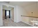 Upstairs hallway with gray carpet, a small sitting area, and a railing at 413 Solace Pl, Canton, GA 30114