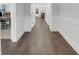 Interior hallway showcasing hardwood flooring and wainscoting, leading to a bright living space at 413 Solace Pl, Canton, GA 30114