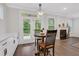 Eat-in kitchen area features a round table with backyard views and access to fireplace living area at 413 Solace Pl, Canton, GA 30114