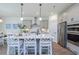 Island kitchen with white cabinets and quartz countertops at 413 Solace Pl, Canton, GA 30114