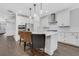Modern kitchen boasts white cabinets, stainless steel appliances, a large island, and hardwood floors at 413 Solace Pl, Canton, GA 30114