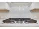 Close-up of stove cooktop with decorative tiled backsplash, offering a stylish and modern cooking space at 413 Solace Pl, Canton, GA 30114