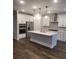 Modern kitchen with white cabinets and center island at 413 Solace Pl, Canton, GA 30114