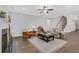 Open living room featuring a cozy sitting area, fireplace, hardwood floors, and staircase to the second floor at 413 Solace Pl, Canton, GA 30114
