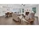 Spacious open-concept living room with hardwood floors, fireplace, and modern kitchen in the background at 413 Solace Pl, Canton, GA 30114